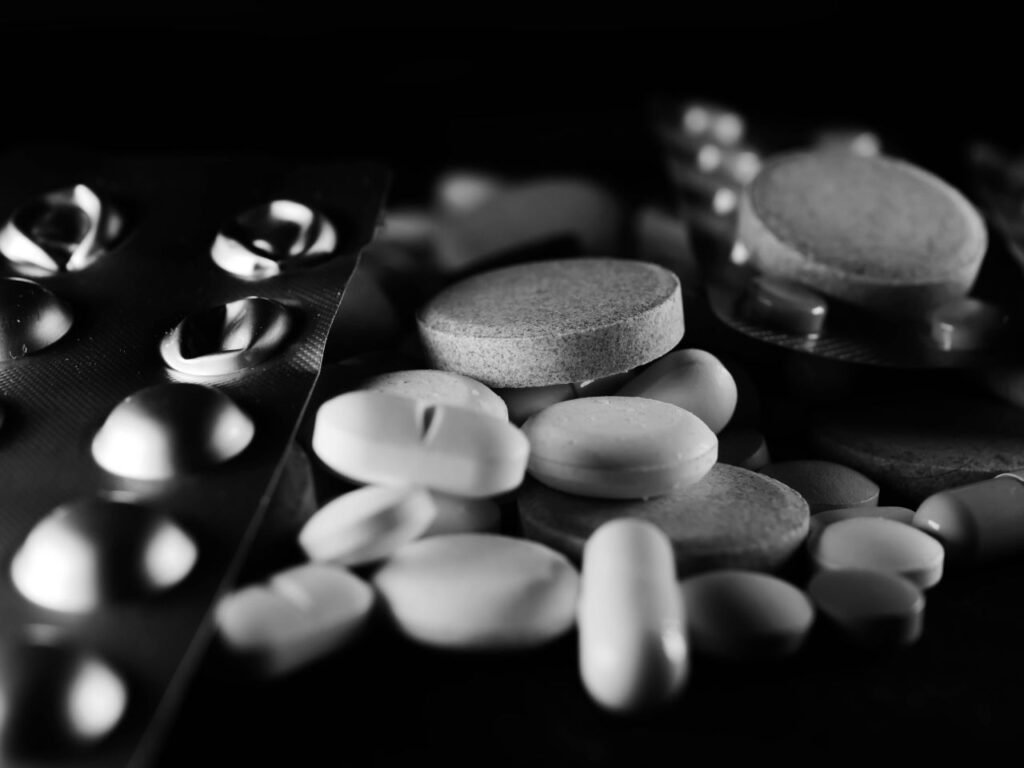 Pills and capsules in black and white picture representing high-risk medicines and over dose issues.